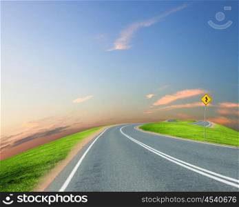 picture of empty road leading toward horizon and cloudy sky
