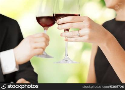 picture of engaged couple with wine glasses in restaurant