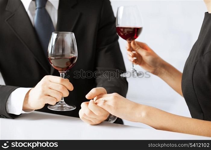 picture of engaged couple with wine glasses in restaurant