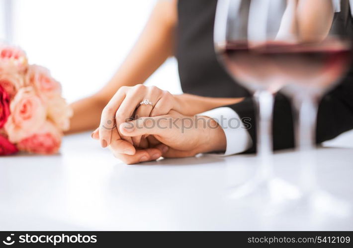 picture of engaged couple with wine glasses in restaurant