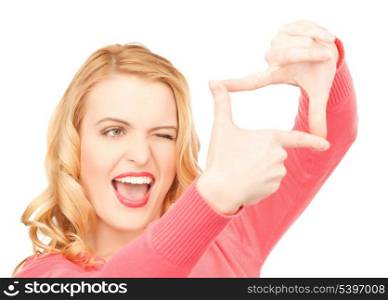 picture of excited woman creating a frame with fingers or snapshot