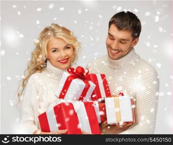 picture of family couple in a sweaters with gift boxes