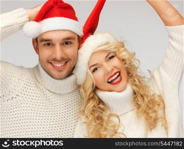 picture of family couple in sweaters and santa&#39;s hats