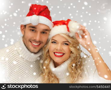 picture of family couple in sweaters and santa&#39;s hats