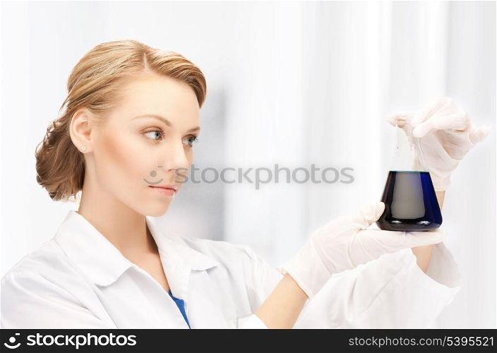 picture of female chemist holding bulb with chemicals