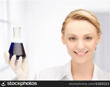 picture of female chemist holding bulb with chemicals
