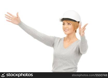 picture of female contractor in helmet working with something imaginary&#xA;
