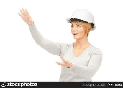 picture of female contractor in helmet working with something imaginary&#xA;