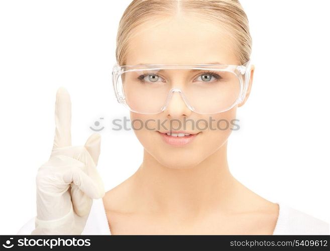 picture of female scientist in eyeglasses holding finger up