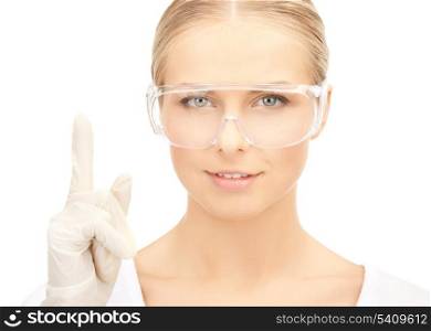 picture of female scientist in eyeglasses holding finger up