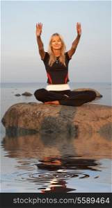 picture of fit girl meditating at the seashore