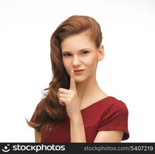 picture of flirting woman showing silence gesture