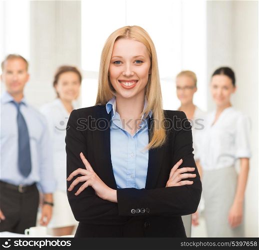 picture of friendly young smiling businesswoman in office