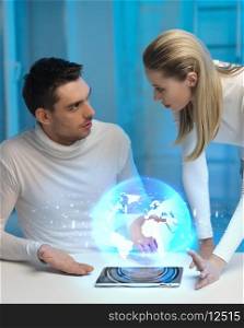 picture of futuristic man and woman with globe hologram