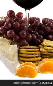 Picture of grapes with crackers, cheese and a red wine glass