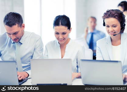picture of group of people working with laptops in office. group of people working with laptops in office