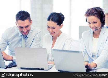picture of group of people working with laptops in office. group of people working with laptops in office