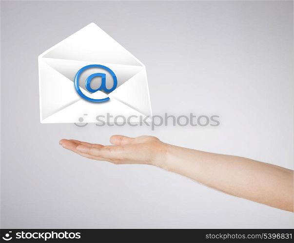 picture of hand holding envelope with email sign