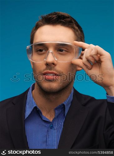 picture of handsome businessman in protective glasses.