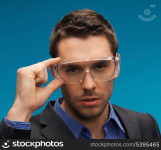 picture of handsome businessman in protective glasses.