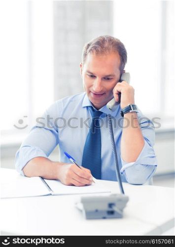 picture of handsome businessman talking on the phone. handsome businessman talking on the phone