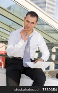 picture of handsome businessman with white laptop computer