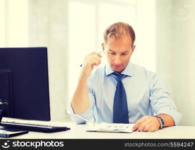 picture of handsome businessman writing in notebook