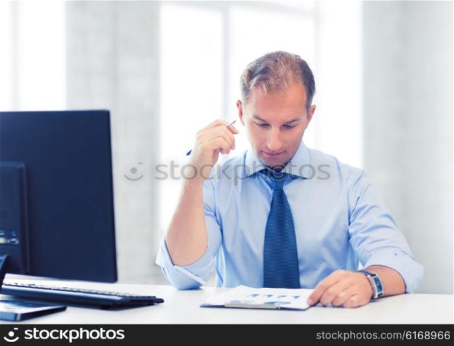 picture of handsome businessman writing in notebook. businessman writing in notebook