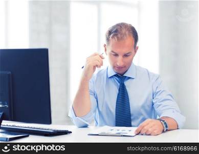 picture of handsome businessman writing in notebook. businessman writing in notebook