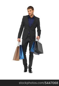 picture of handsome man in suit with shopping bags.