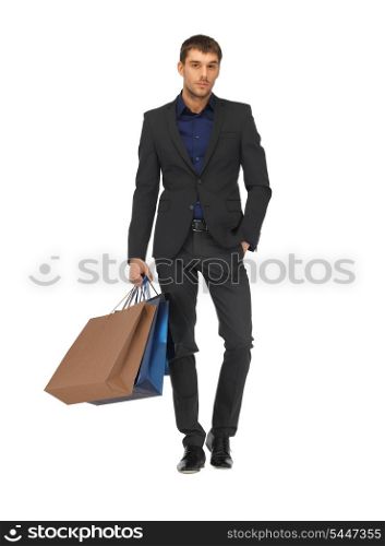 picture of handsome man in suit with shopping bags.