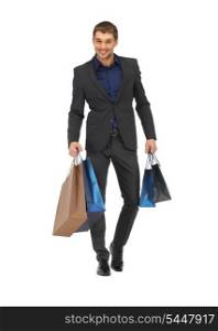 picture of handsome man in suit with shopping bags.