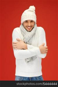 picture of handsome man in warm sweater, hat and scarf.