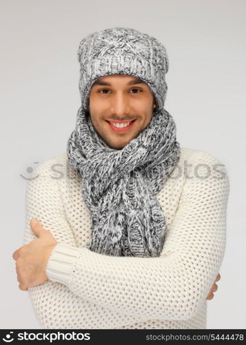 picture of handsome man in warm sweater, hat and scarf.