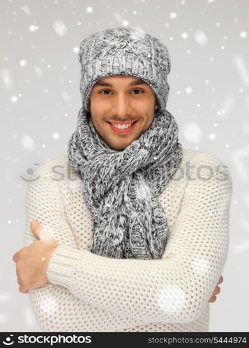 picture of handsome man in warm sweater, hat and scarf.