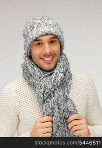 picture of handsome man in warm sweater, hat and scarf.