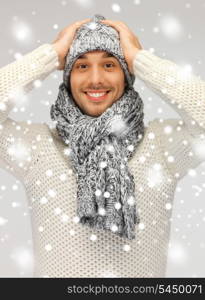 picture of handsome man in warm sweater, hat and scarf.