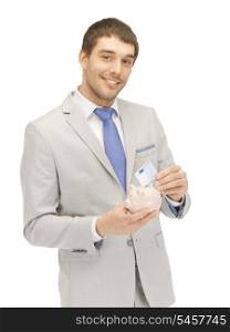picture of handsome man with piggy bank and money