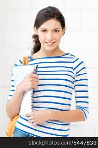 picture of happy and smiling teenage girl with big notepad