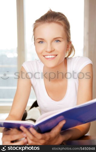 picture of happy and smiling teenage girl with big notepad