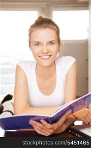 picture of happy and smiling teenage girl with big notepad