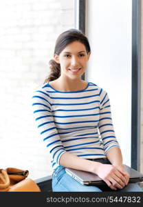 picture of happy and smiling teenage girl with laptop