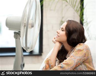 picture of happy and smiling woman sitting near ventilator