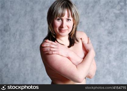 picture of happy blond 20-25 years topless in studio on grey