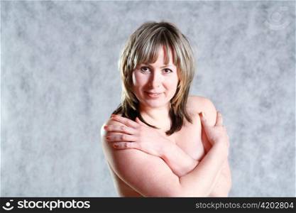 picture of happy blond 20-25 years topless in studio on grey