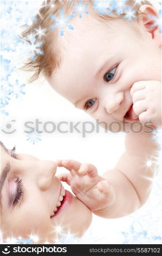 picture of happy blue-eyed baby boy touching mama