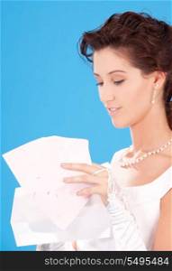 picture of happy bride with envelopes over blue