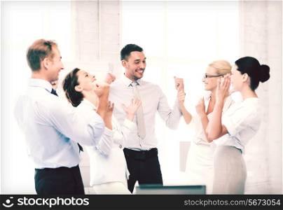 picture of happy business team celebrating victory in office