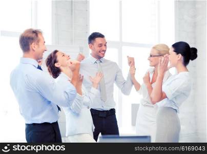 picture of happy business team celebrating victory in office. business team celebrating victory in office