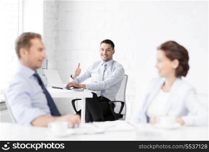 picture of happy businessman showing thumbs up in office